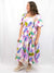 pastel multi color printed midi dress from front side on model