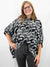 black button up blouse with white tigers and polka dots on model front tucked