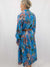 back of safari print blue dress on model.