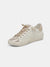 white body zina sneaker with gold metallic details from front side