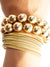 large gold bead bracelet set layered with bangles