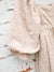 close up of beige babydoll dress