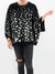 black and white spotted sweater on model
