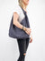 grey suede hobo bag on person
