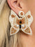 seed bead butterfly earrings in ivory on model
