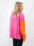 orange, pink, and tan turtleneck sweater from back