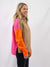 orange, tan, and pink turtleneck sweater on model