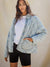 Blue quilted jacket on model