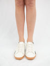 White sneaker wtih black and brown detail from front