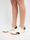 White sneaker wtih black and brown detail from side