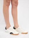 White sneaker wtih black and brown detail from side