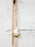 gold dipped pearl on gold chain necklace close up