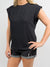 black shoulder pad top paired with denim shorts