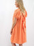 coral gauze dress from back with criss cross tie