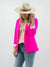 woman in pink blazer styled with graphic tee, denim, and wide-brim hat, sleeves rolled up