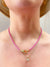 pink pave choker necklace on model with layered pendant necklace