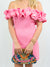 pink ruffle mini dress from front with clutch