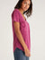 woman in berry pocket tee from the side