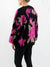 floral sweater in black and pink on model from back