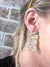 jeweled serpent earrings being worn