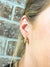 gold spiked huggie earrings being worn