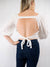 Linen look crop top with balloon sleeves and self tying open back.