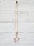 gold chain necklace hanging with white pave large star pendant