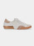 Tan, white, and gold fashion sneaker from side.
