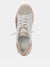 Tan, white, and gold fashion sneaker from top.